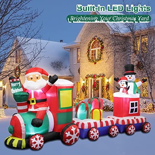 Christmas inflatable train with Santa, snowman, and gifts in snowy yard.