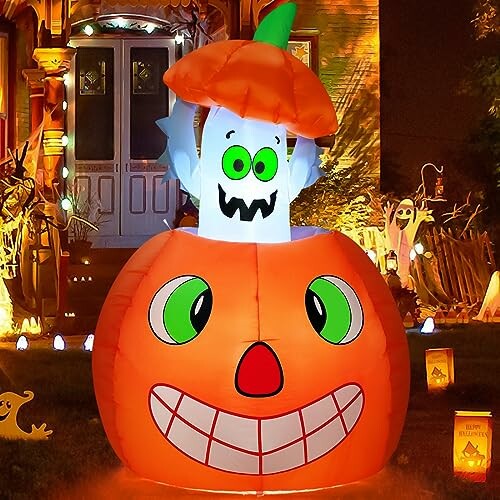 Inflatable pumpkin with a ghost for Halloween decoration in front of a house.
